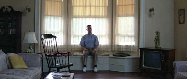 Forrest Gump sits on window seat in bay window of house