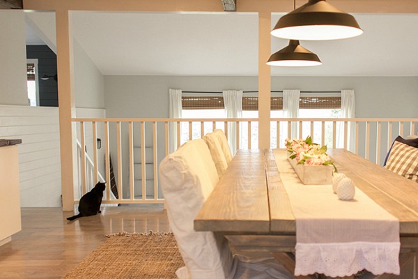 kitchen table with black cat sitting on ground