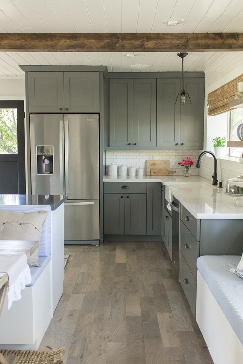 kitchen with gray cabinets and white subway tile