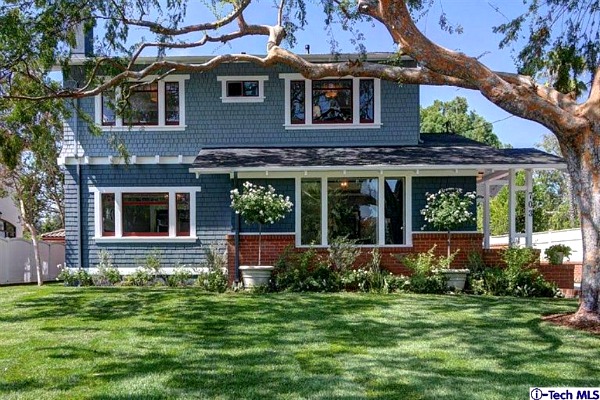 Blue siding with red brick and door on Craftsman