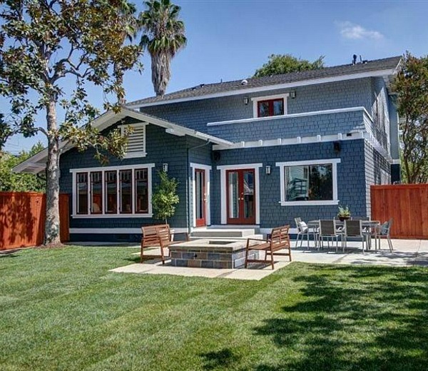 back of house with blue siding and red trim