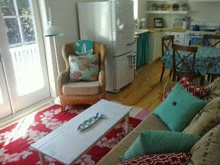 A living room filled with furniture and a rug