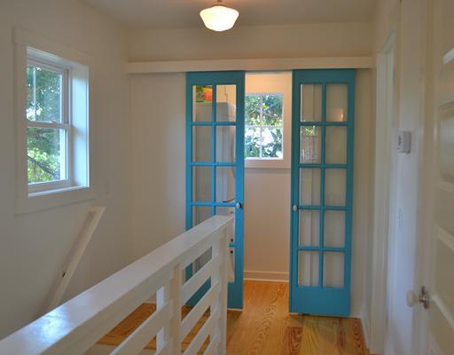 double doors painted teal leading to laundry room