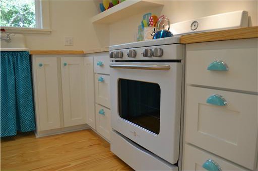 A stove top oven sitting inside of a kitchen