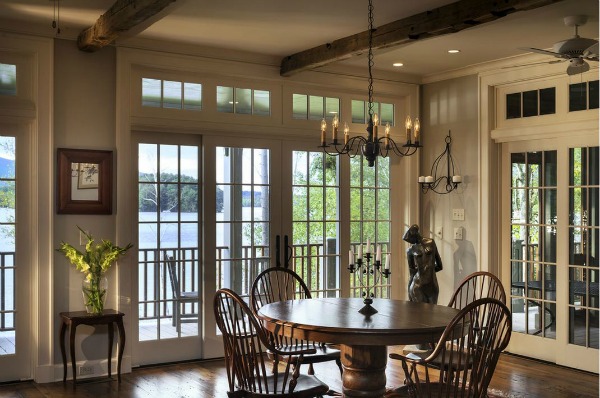 A dining room filled with furniture and a large window