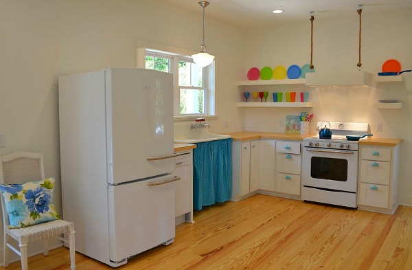 A kitchen with a stove and a refrigerator