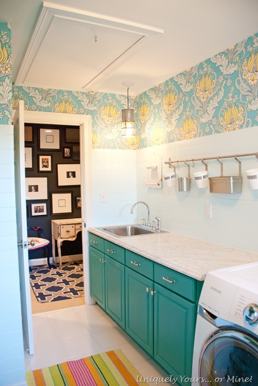 colorful laundry room makeover with teal cabinets