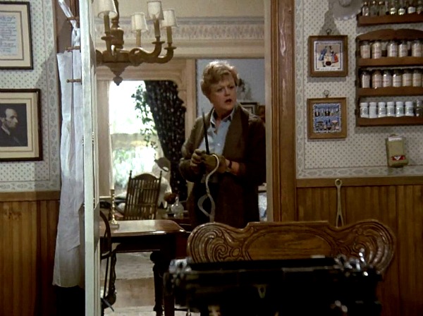 Angela Lansbury leaning against kitchen doorframe