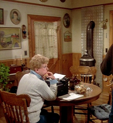 Jessica Fletcher typing on typewriter at table