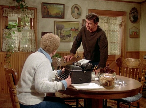 Jessica Fletcher sitting at table with typewriter