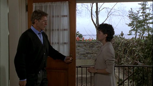 A woman standing in front of a door with Harrison Ford