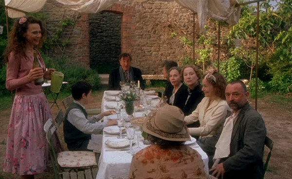 friends sitting around a table in the backyard