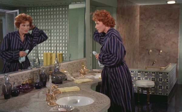 Maureen O\'Hara standing in the bathroom mirror