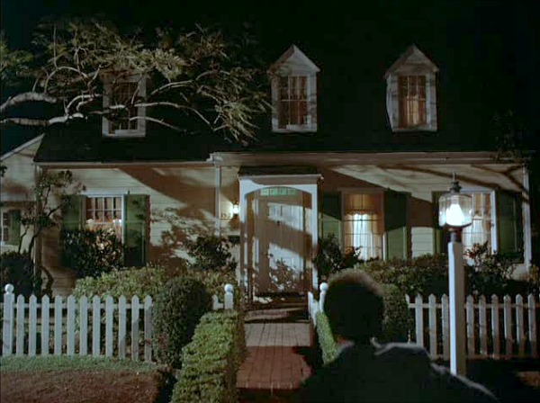 Cape Cod house from Mr. Mom movie at night with lights on