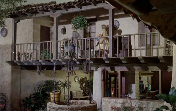 twin girls walking across second floor balcony