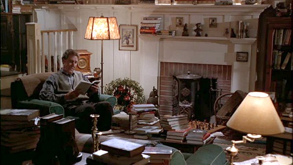 A living room filled with books and a fire place