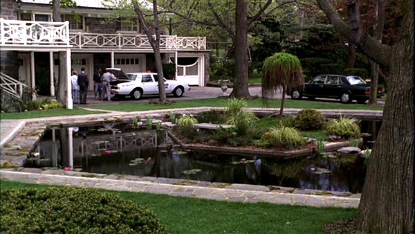 exterior of the coach house and garage and koi pond