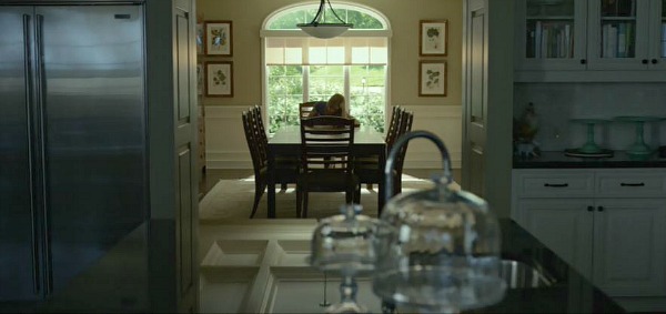 A dining room table in front of a window