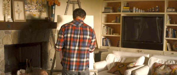 Mark Duplass drawing on an easel in the living room