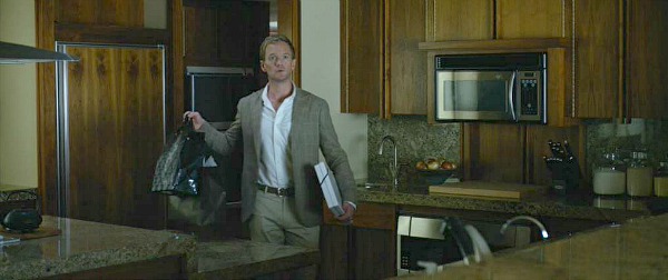 Neil Patrick Harris stands in kitchen of lake house