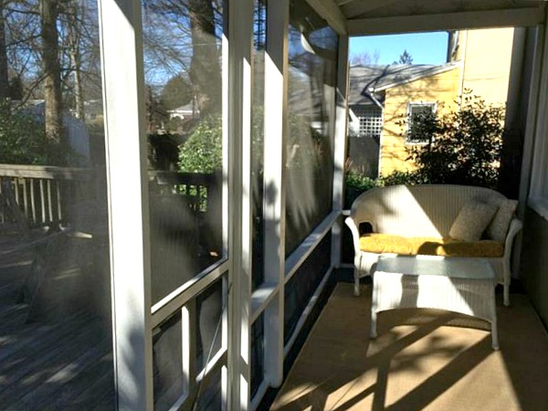 screened porch with wicker sofa