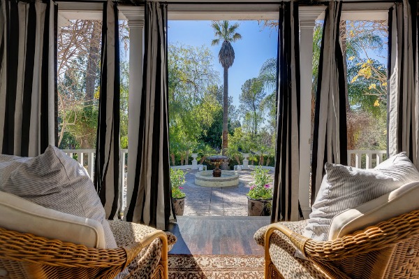 view from porch of fountain and palm trees