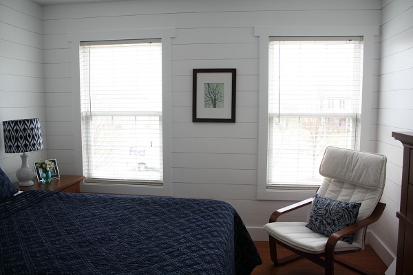 corner of bedroom with fake shiplap on wall