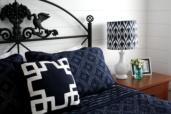 close up of blue and white bedding and black headboard