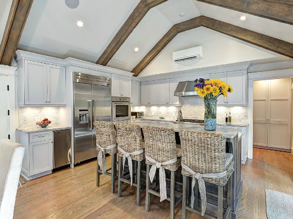 newly remodeled kitchen with rattan bar stools and blue cabinets