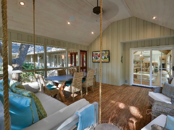 screened porch with table and chairs