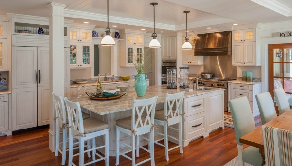 A kitchen with island and barstools