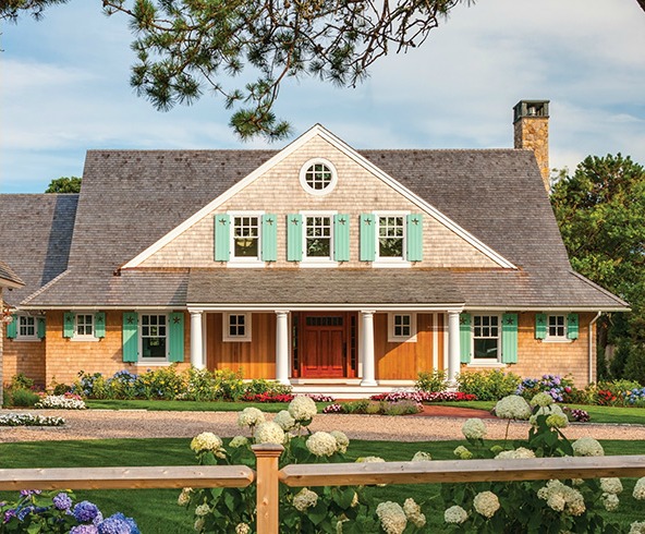 front exterior of shingle style beach house with aqua shutters