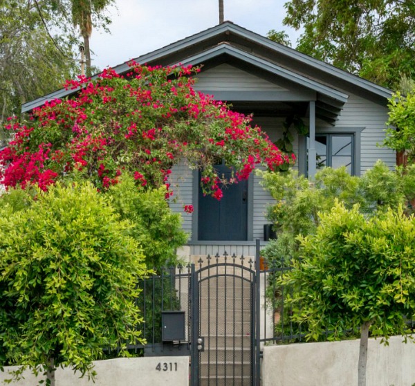 A house with bushes in front of a building