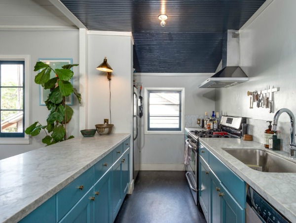 galley kitchen with blue cabinets