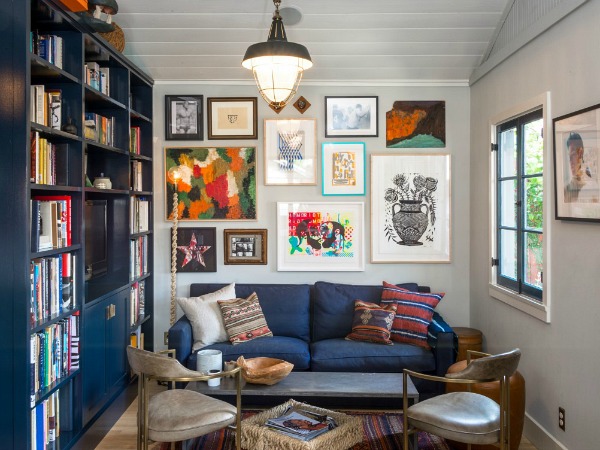 A living room filled with furniture and a book shelf