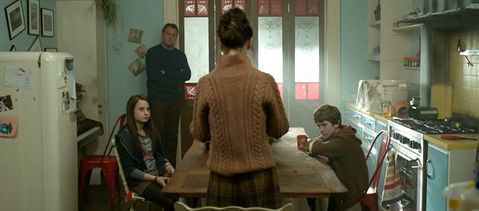 family gathers around kitchen table