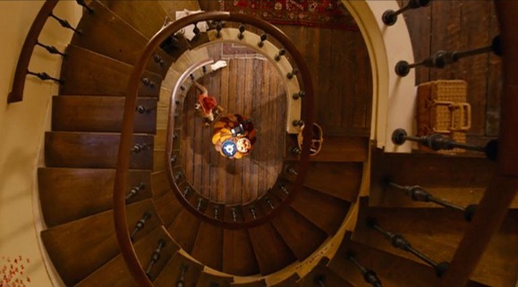 Looking down curving staircase from top floor
