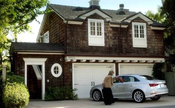 car parked outside shingle style garage