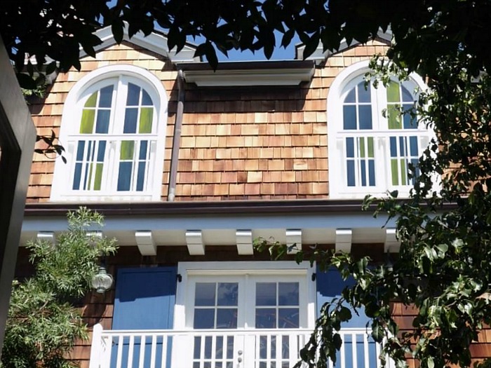 exterior of shingle style pool house with stained glass windows