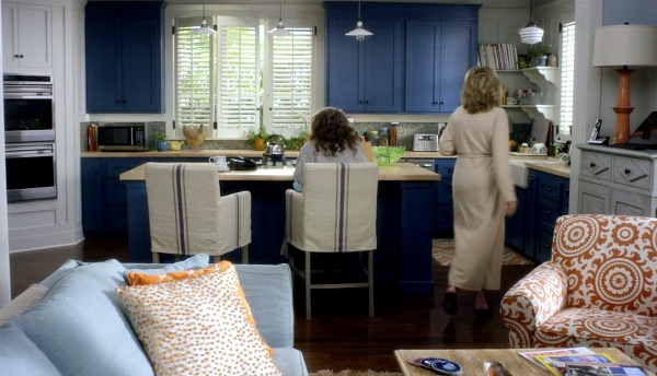 Lily Tomlin and Jane Fonda in the beach house kitchen with blue cabinets