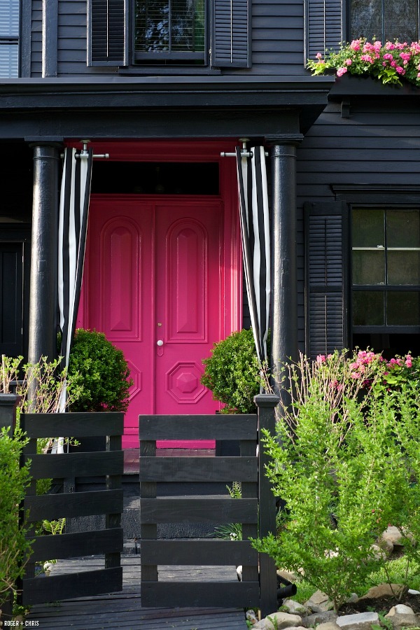 Black house with hot-pink front door