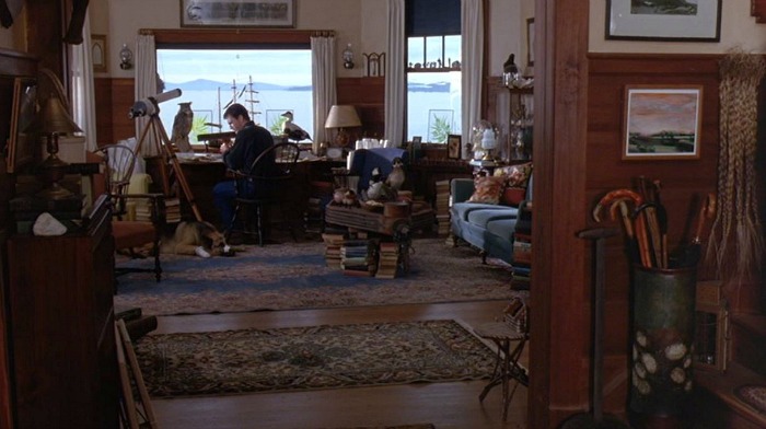 Mel Gibson\'s character sitting at his desk in front of the window