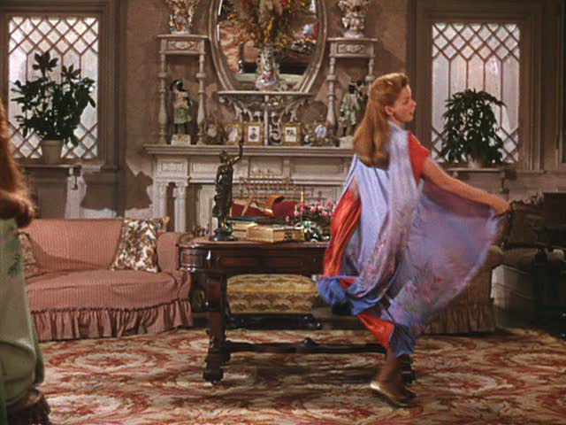 Judy Garland dancing in front of a fireplace in the parlor