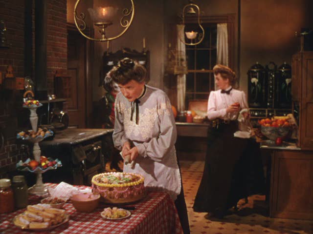 mother and maid preparing food in the kitchen