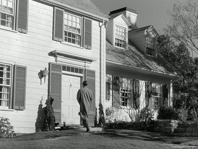 Cary Grant walks up to front door of house