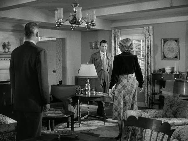 A man standing in a room, with Cary Grant