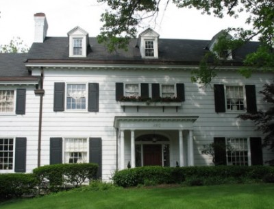 front exterior of white house with shutters