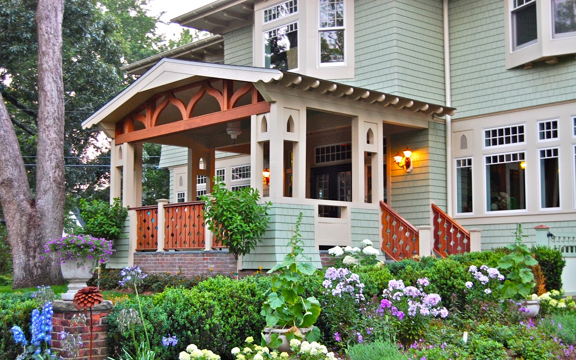 A close up of a flower garden in front of a house