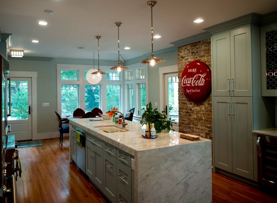 kitchen with exposed brick wall and large marble island