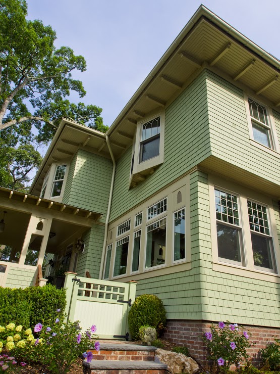 close up of green siding on exterior of house